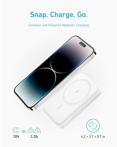 Phone with magnetic charger showing specifications.